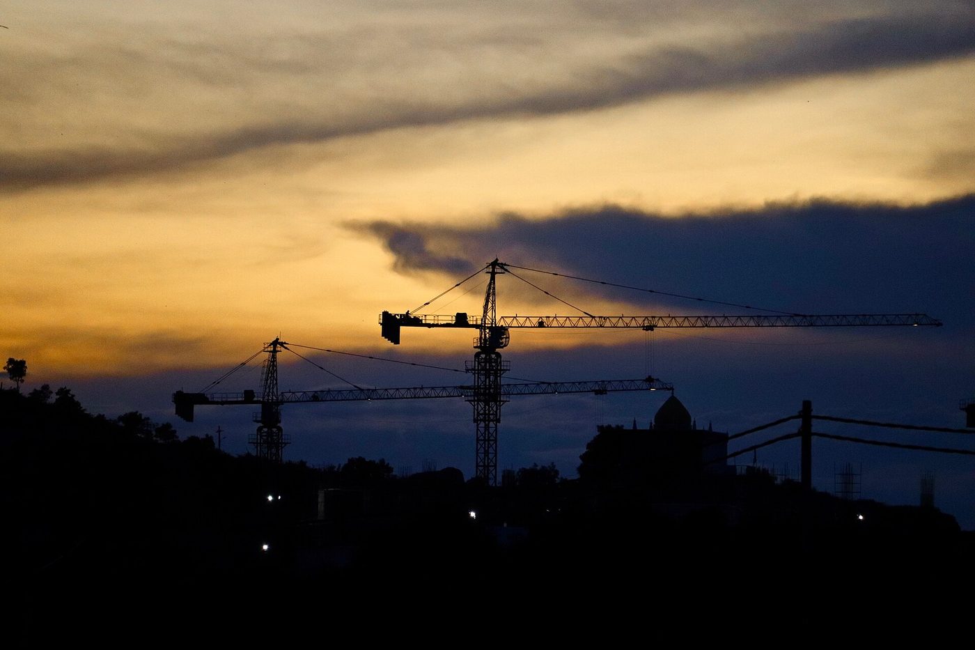 A tall construction crane above a building site