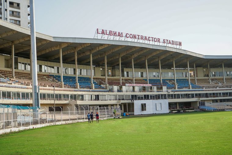 Players training on a cricket ground beside the stands