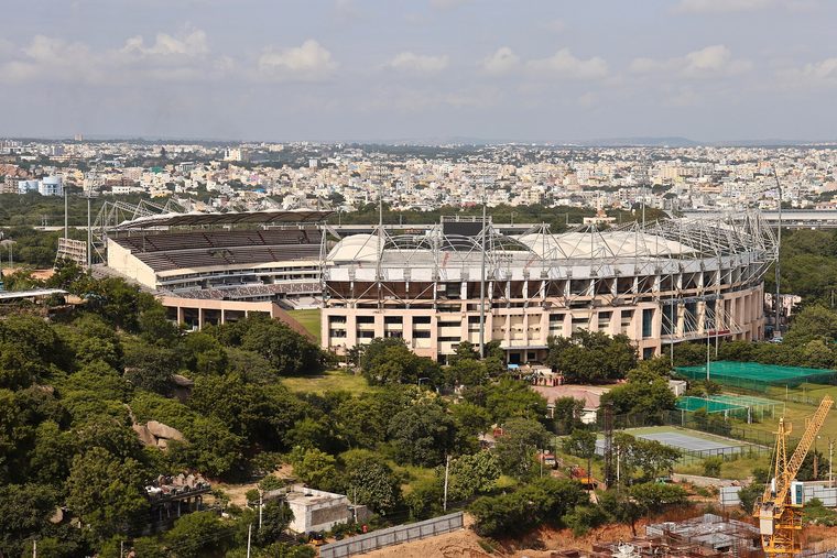 A floodlit stadium bowl seen from the upper tier