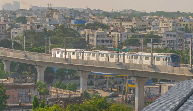 A metro train pulling into an elevated station