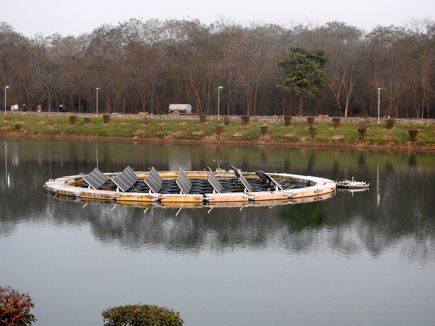 Open water and embankment beside a power utility site