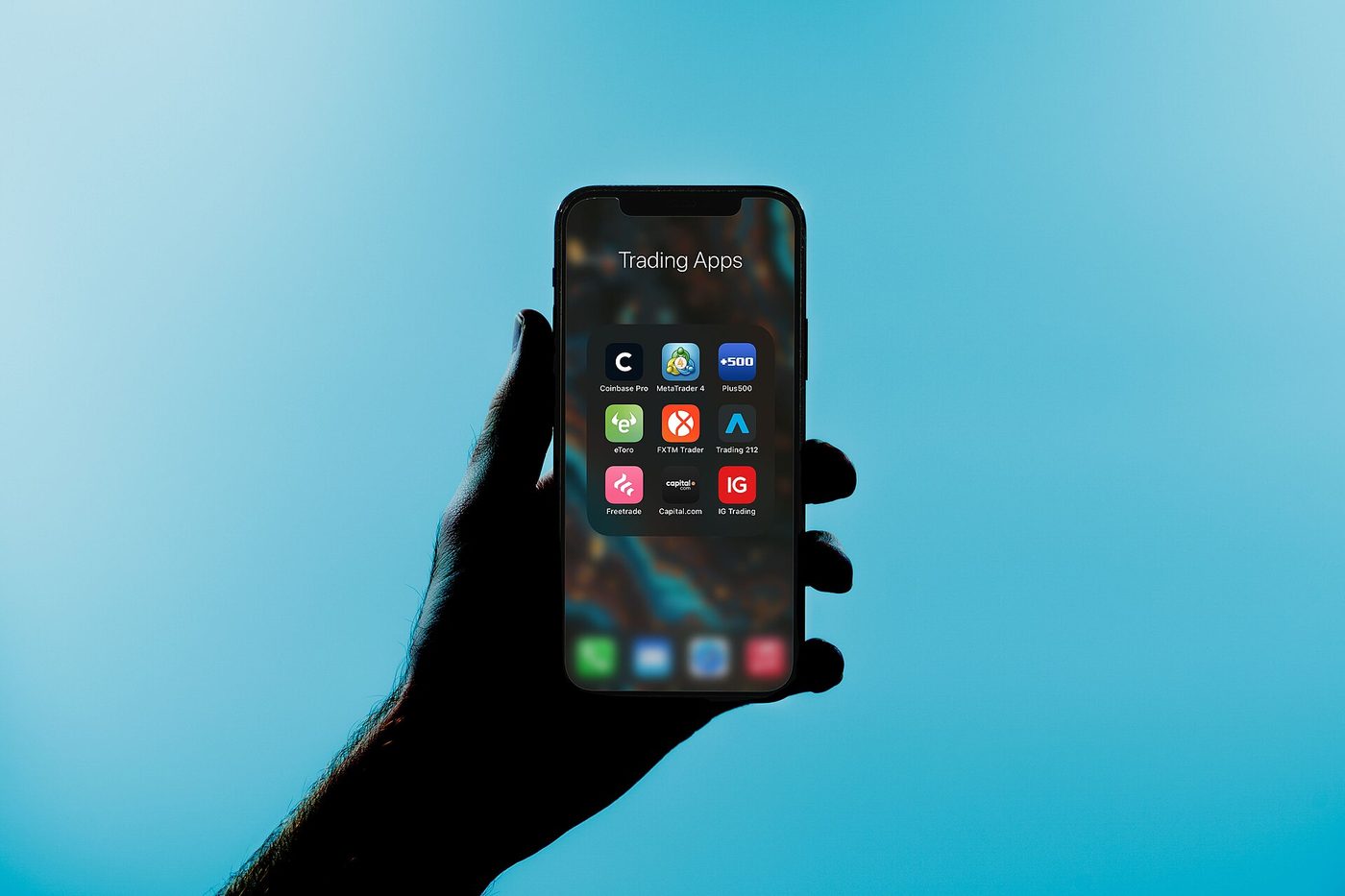 A phone screen showing a folder of share-trading apps